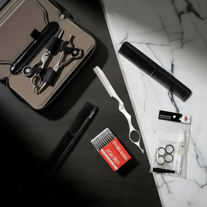 Scissor kit with zip pouch, scissors, combs and a razor on wood and marble