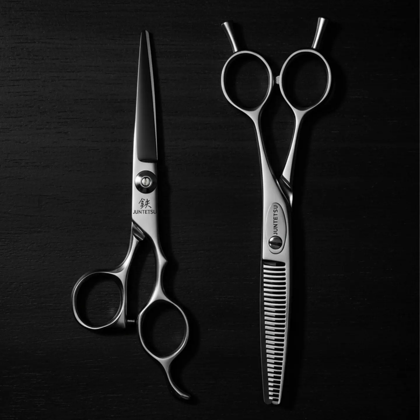 Juntetsu Cobalt Apex cutting and thinning scissors side by side on black wood