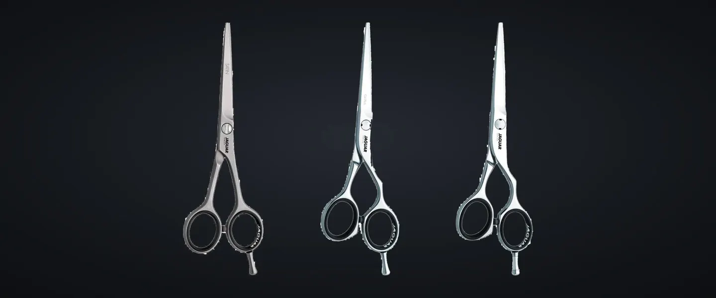Three Jaguar cutting scissors from the White, Silver and Gold lines on charcoal