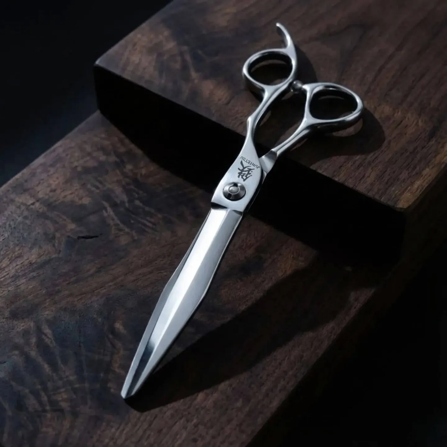 Juntetsu Sword cutting scissors resting on a dark burl wood block