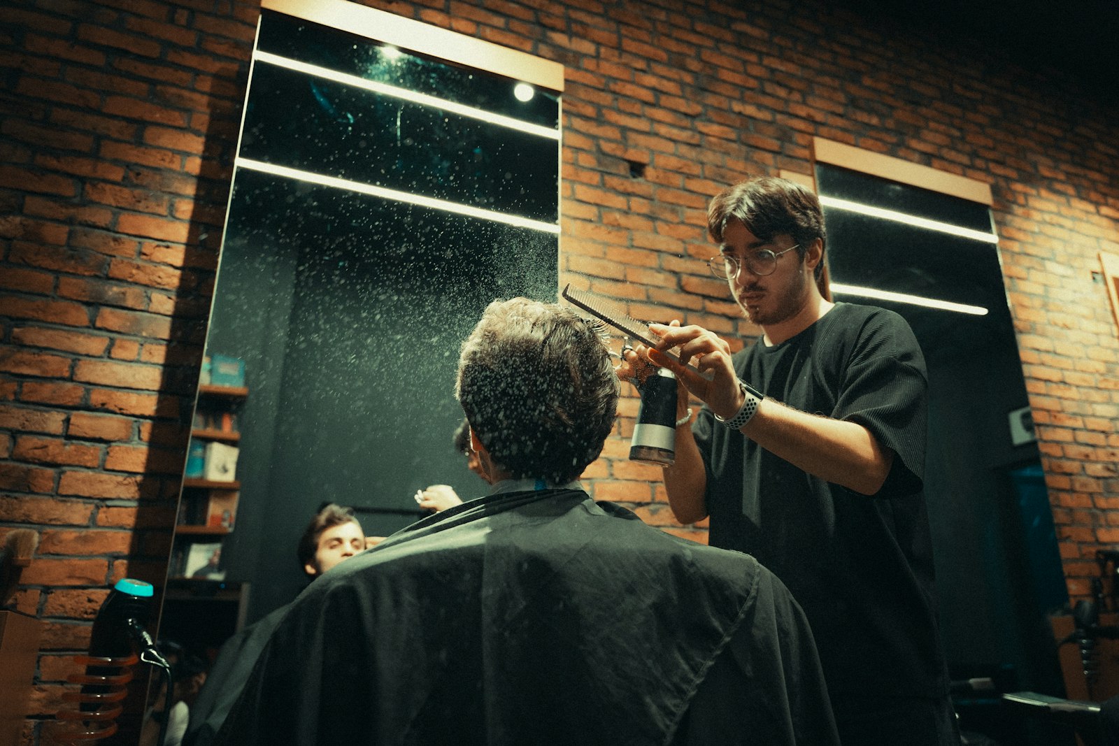 Apprentice barber practising under mentor supervision