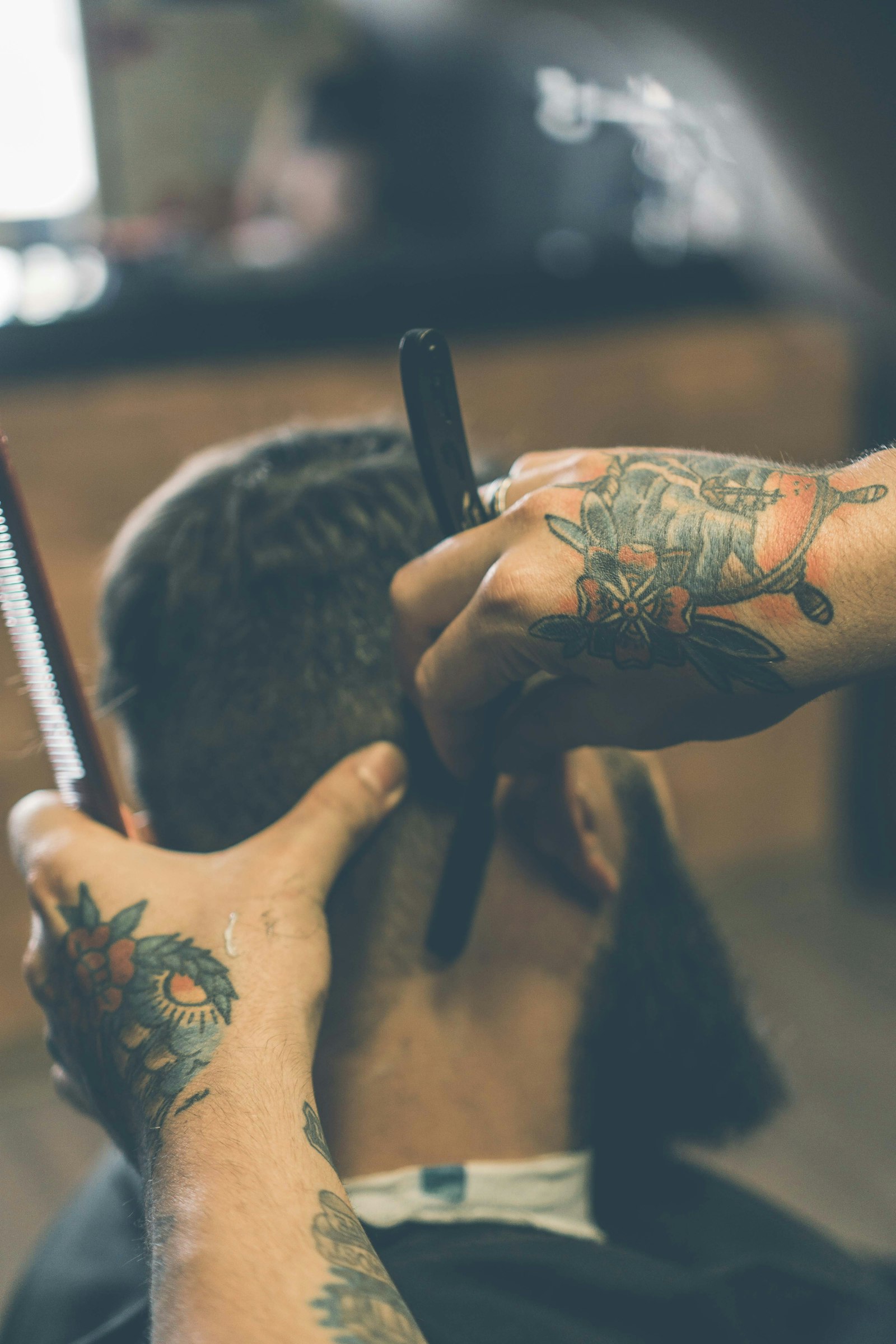 Left-handed barber detailing a fade with shears