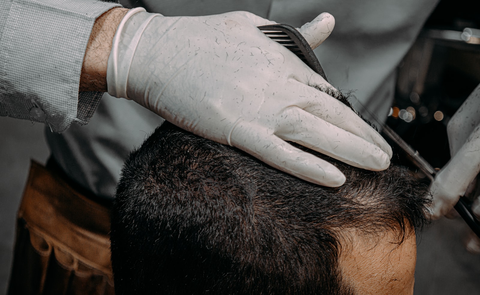 Barber using ergonomic shears on a client